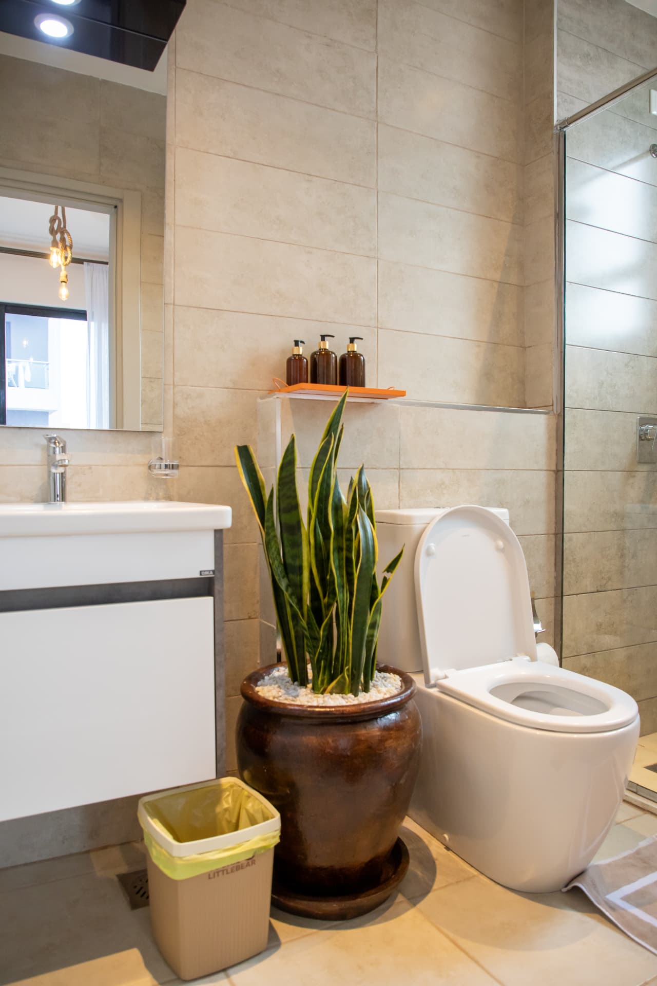 Second bathroom with vanity and potted plant