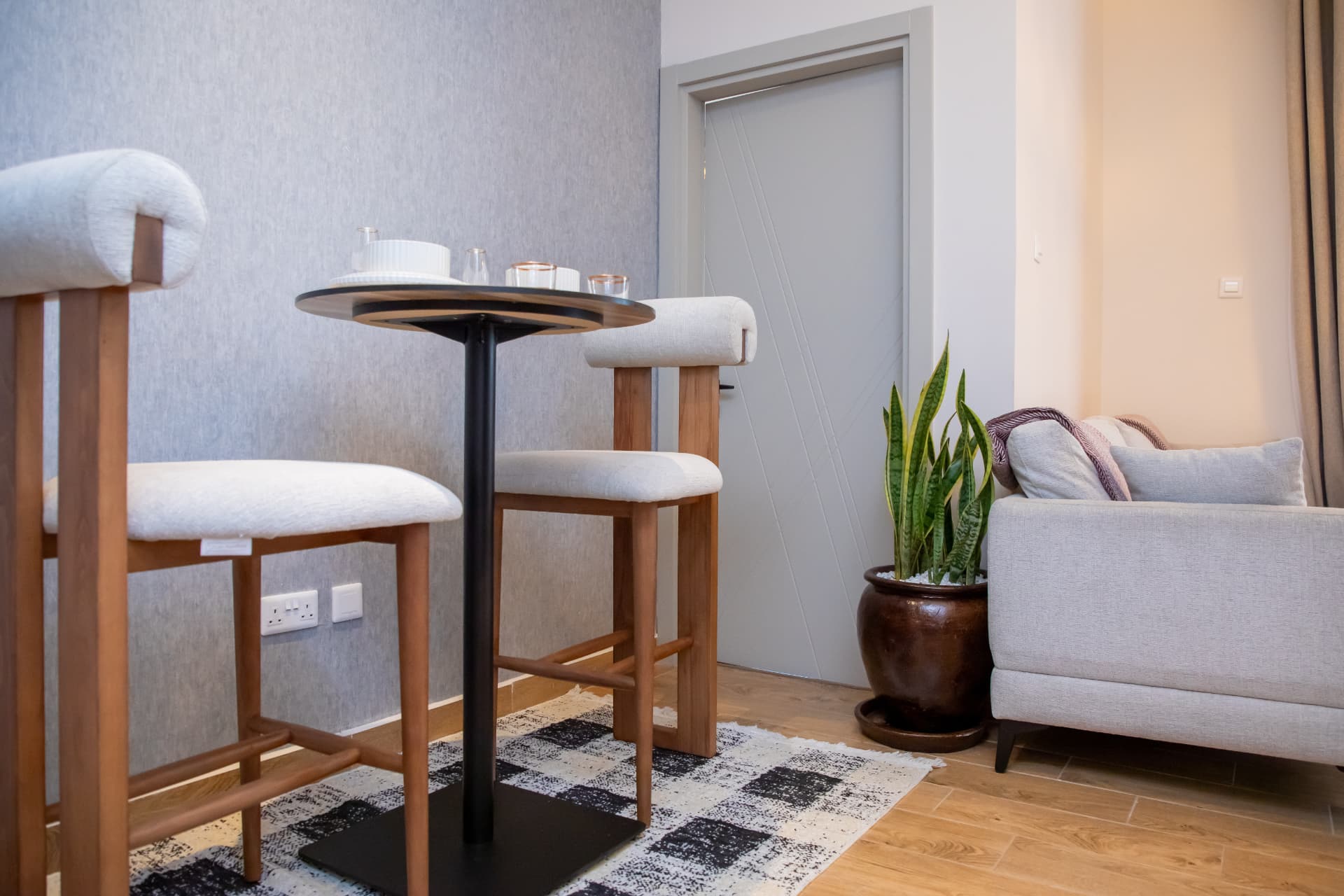 Bar-height table for two with upholstered stools
