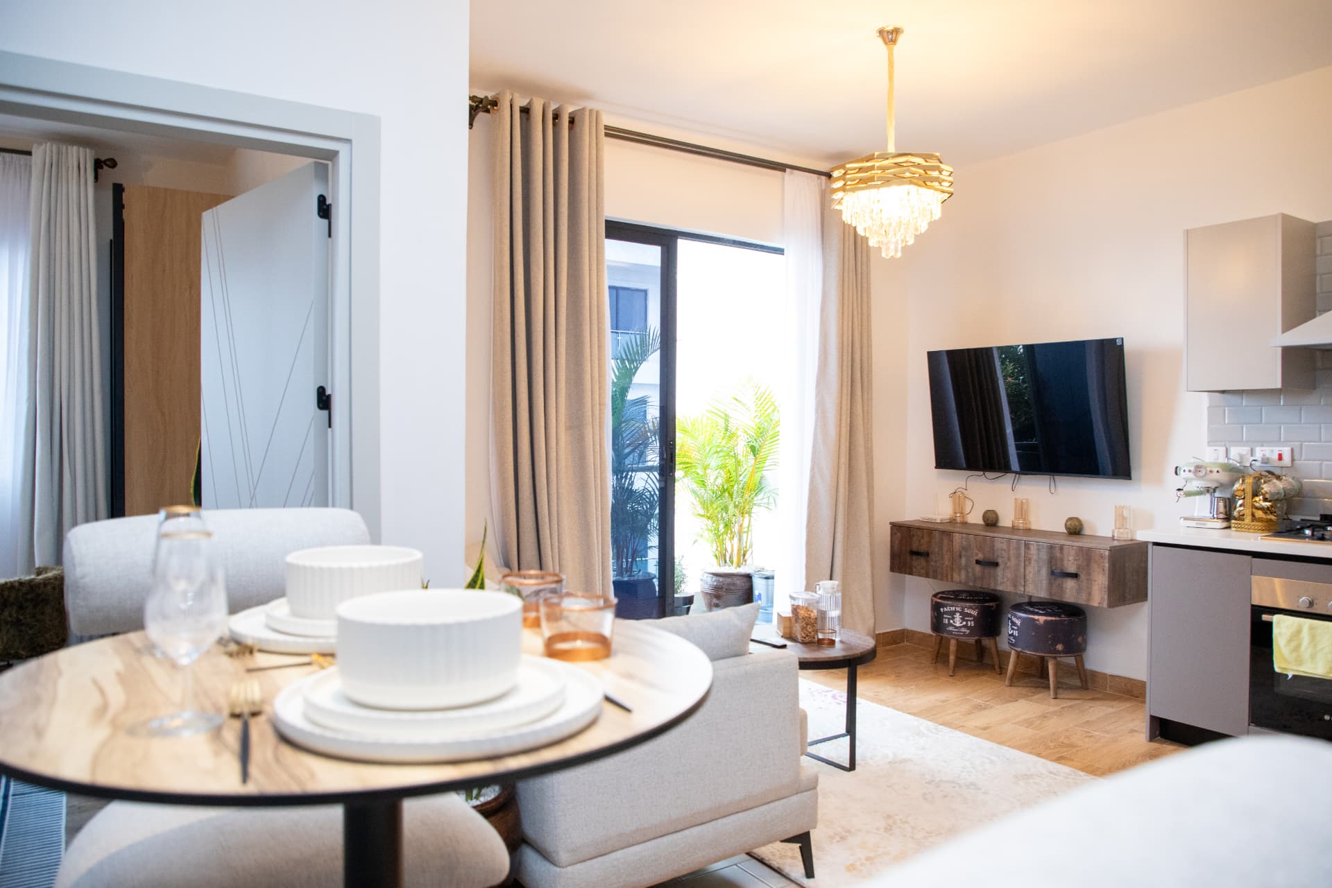 Dining setting looking through to the sofa, TV wall and kitchen