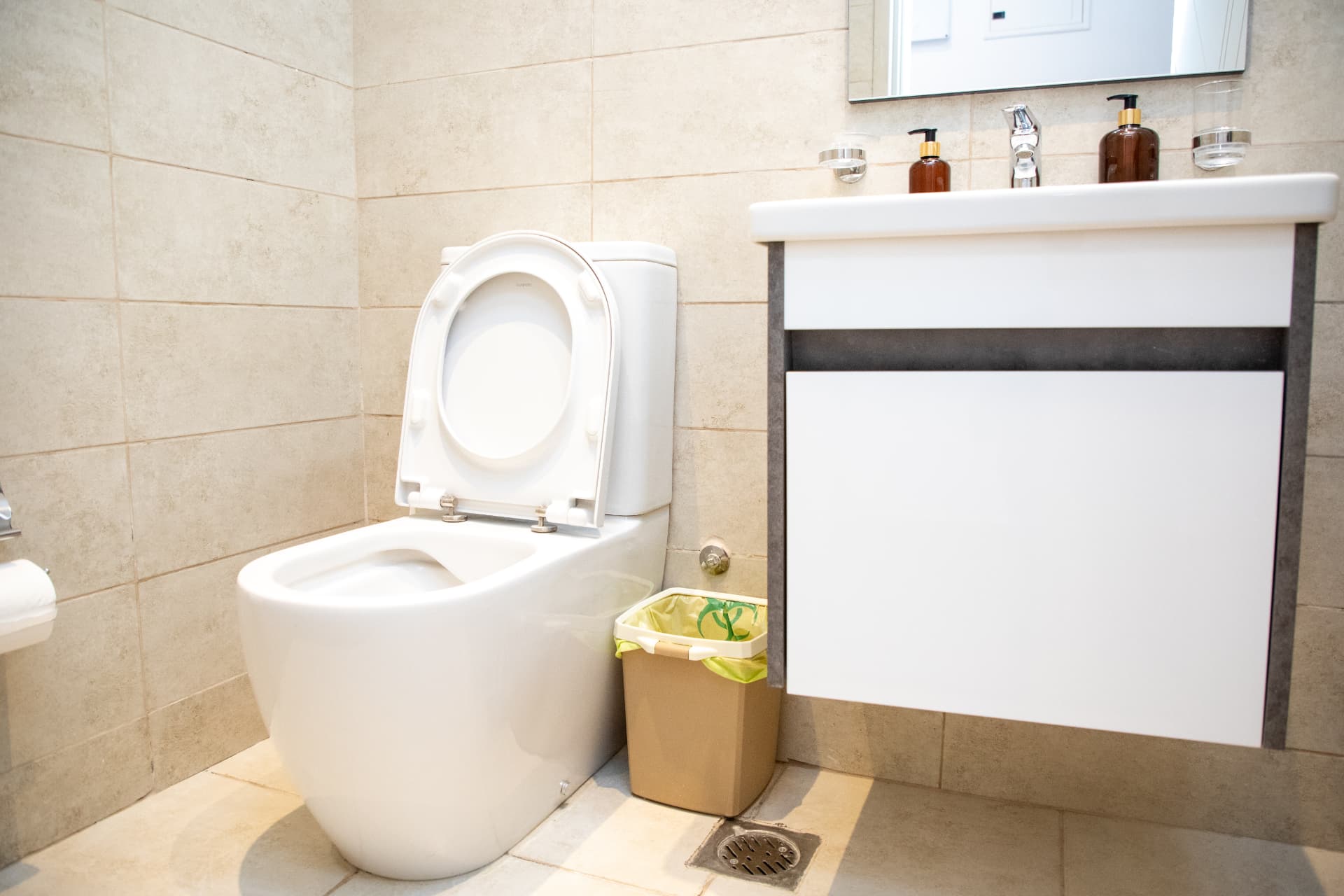 Bathroom with vanity unit and stone-tiled walls
