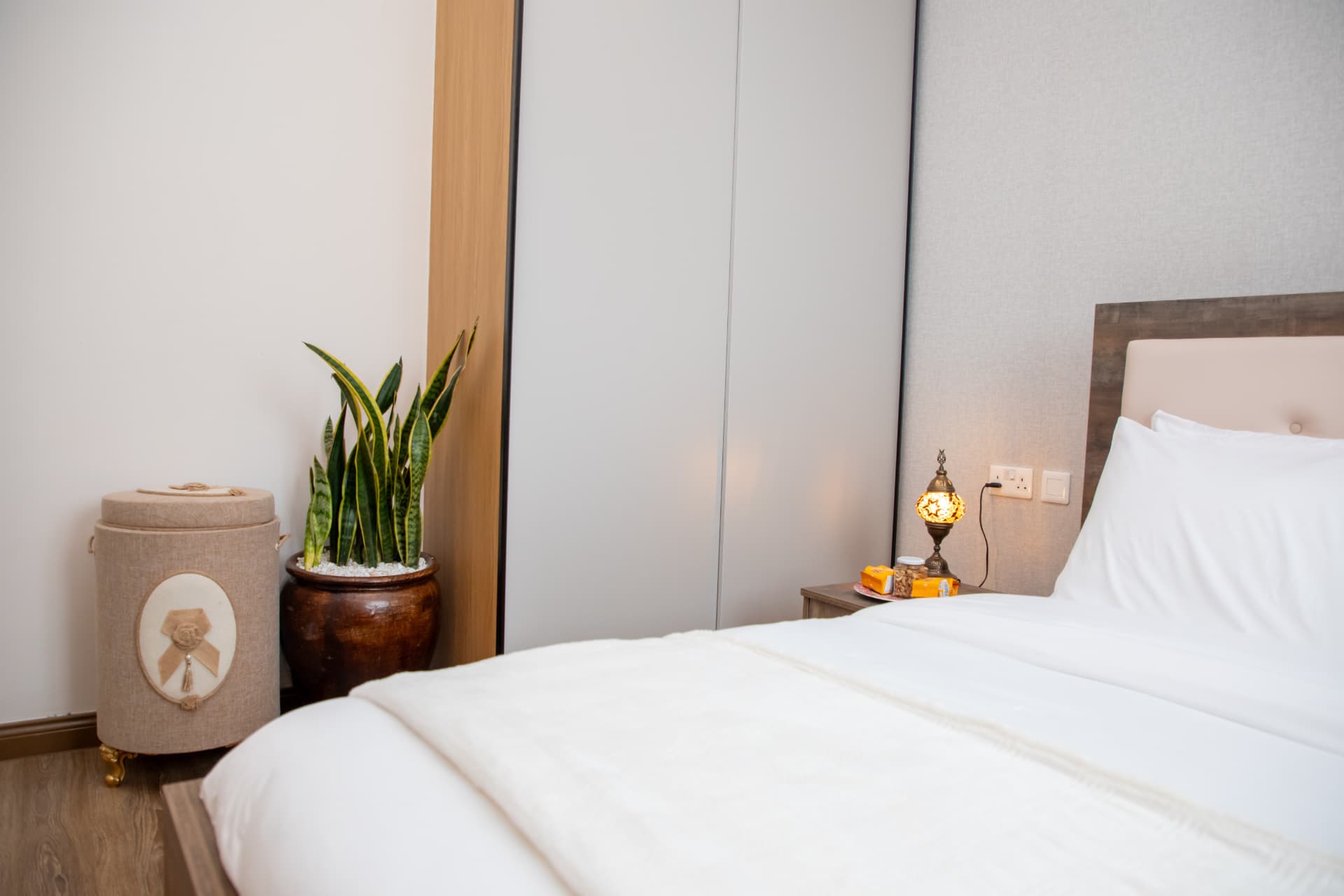 Bedroom corner with wardrobe, plant and laundry basket