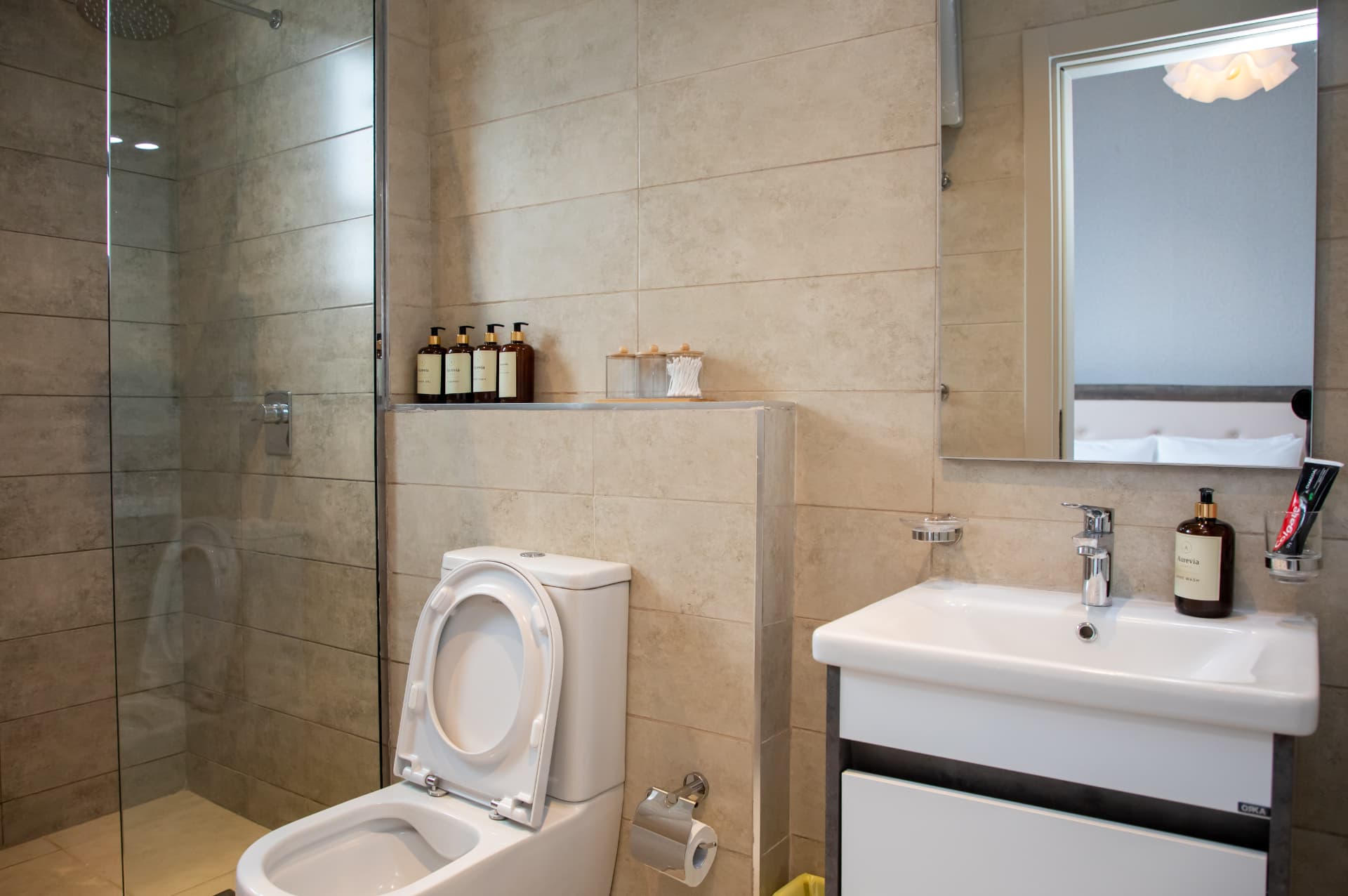 Bathroom with walk-in shower, vanity and mirror