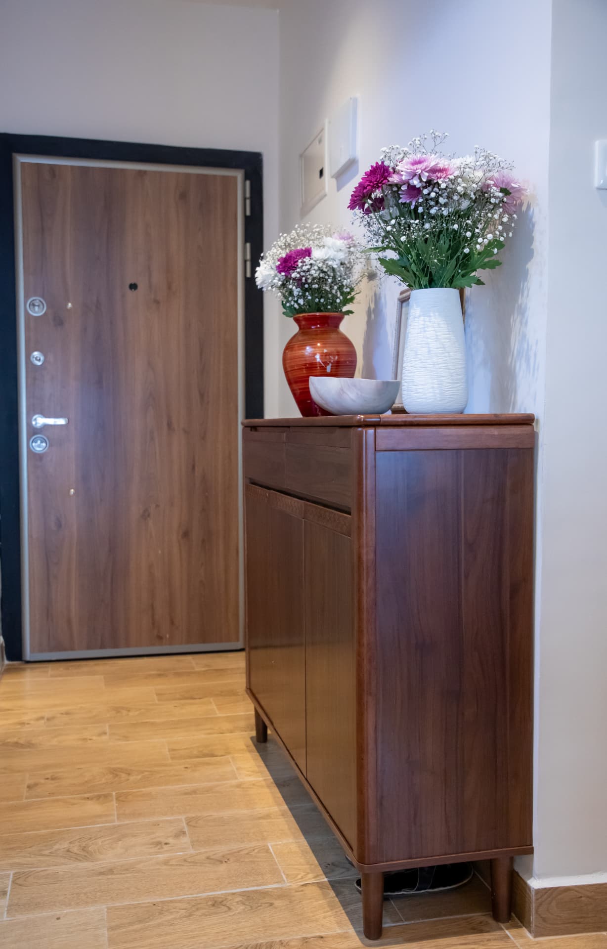 Entry console with fresh flowers beside the front door
